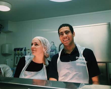 Feeding the homeless , and looking fab in a hair net.
